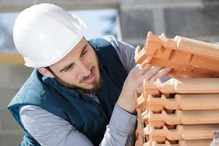 builder working on roof tilesの写真素材