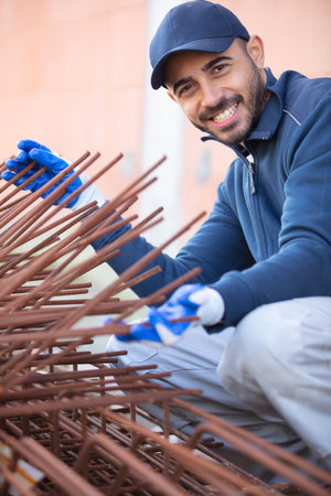 worker fixing steel rebar at building siteの写真素材