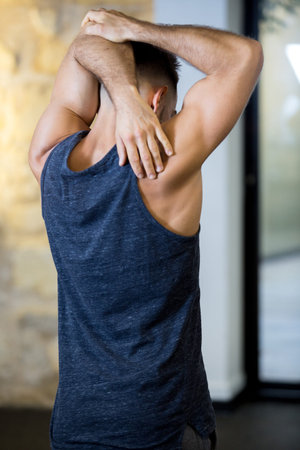 man stretching his arms in fitness class