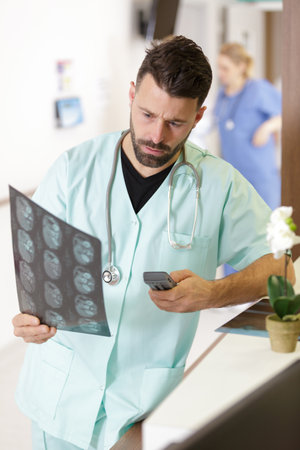 confused doctor looking at magnetic resonance imagingの写真素材