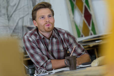 young handsome designer working at modern coworking studioの写真素材