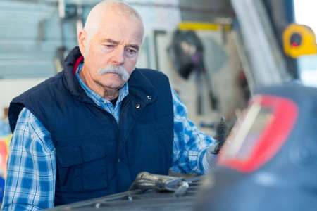 older male steel worker with protective maskの写真素材