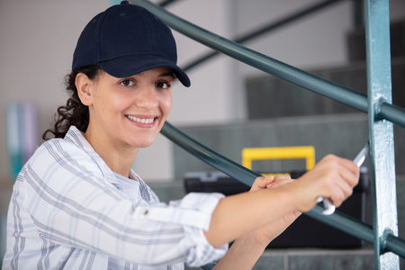 woman fixing safe rails on staircase