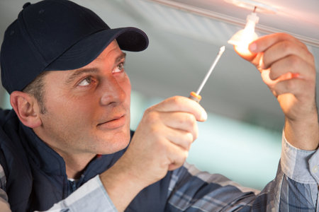 man wiring light on the ceilingの写真素材