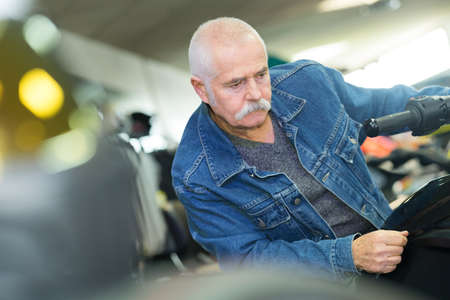 man checking motorbike products on displayの写真素材