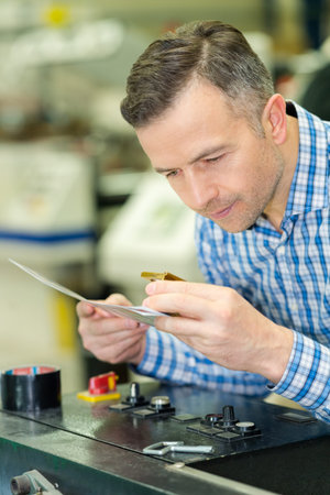 man controlling calibration in computer to plate department