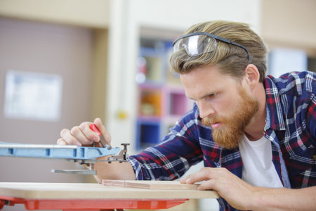 carpenter doing his job in carpentry workshopの写真素材