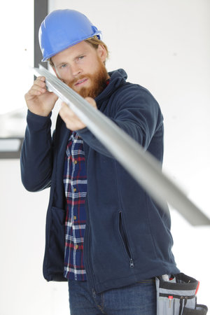 portrait of construction worker carrying steel blade