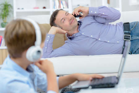 man teasing a young boyの写真素材