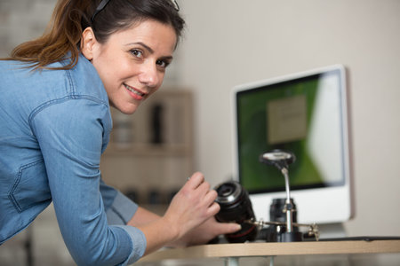 woman engineer repairing camera lens