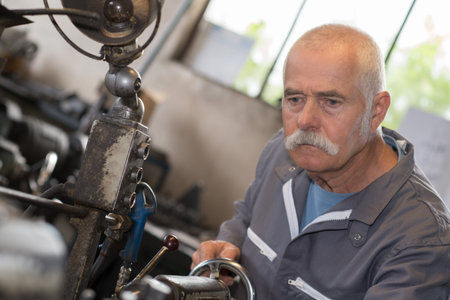 senior man on milling machine