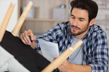 man carpenter working in furniture repair workshopの写真素材