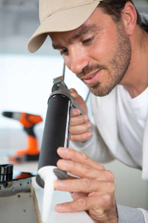 a man assembling kitchen furnitureの写真素材