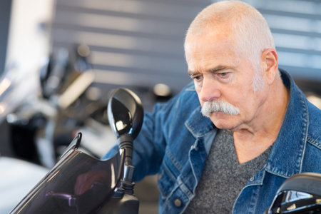 senior mechanic with motorized bicycle