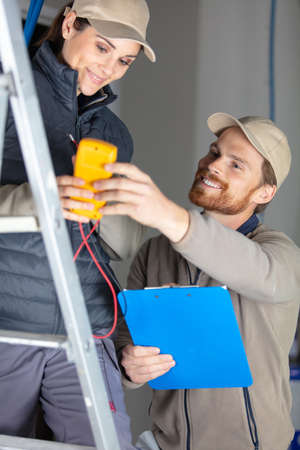 electrician and her male apprenticeの写真素材