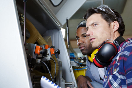two worker in factory on the machine