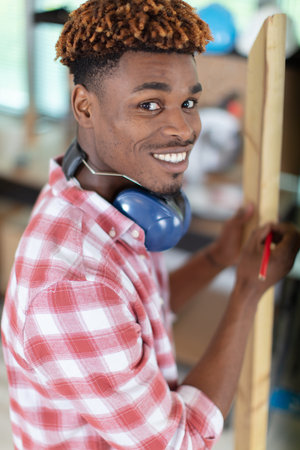 portrait of handsome carpenter with penci
