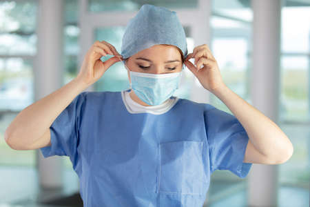 female nurse staring out the windowの写真素材