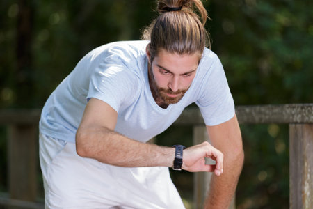 smartwatch runner man checking progress on smart fitness sport watch