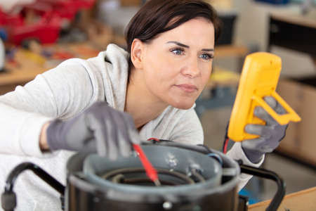girl with measuring devices in the electronics laboratoryの写真素材