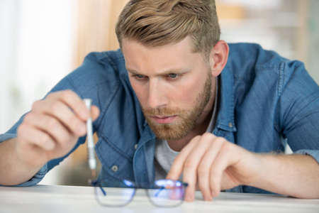 optician fixing glasses with bending pliersの写真素材