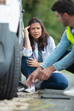 couple on the road having problem with a car