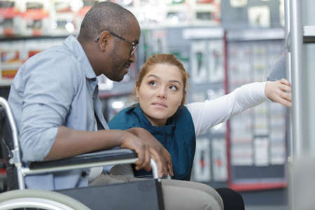 female consultant talking to customer in orthopedic storeの写真素材