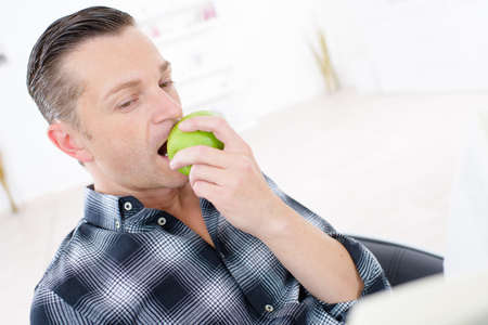 a man is a man eating appleの写真素材