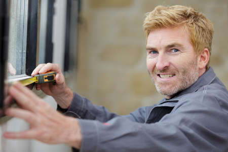 a man is measuring windowの写真素材