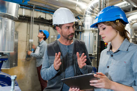 man and woman work in manufacturing factoryの写真素材