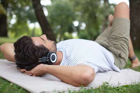 handsome man on the grass relaxingの写真素材