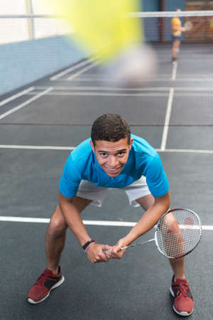 portrait of young male badminton player crouched into positionの写真素材