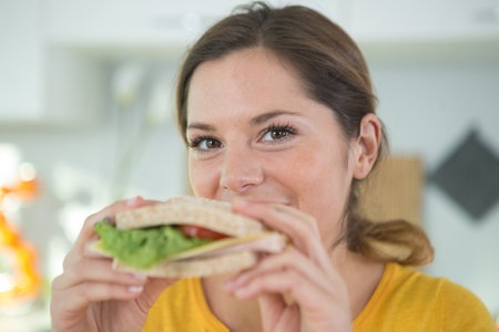 happy woman holds plate with ready sandwhichesの写真素材
