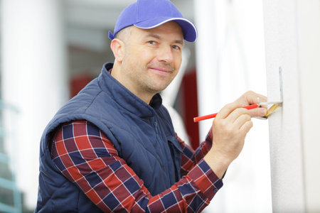 portrait of a handsome man writing on the wallの写真素材