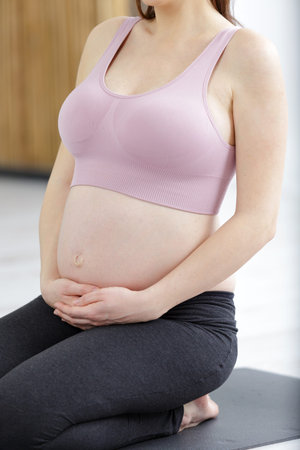 pregnant woman is relaxing on the floor