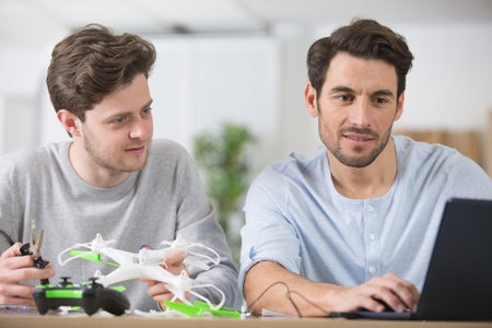 two male friends assembling drone