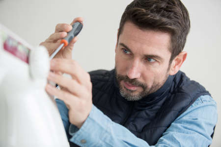 locksmith fix wood door by screwdriver in customer houseの写真素材