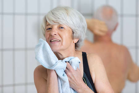 woman cleaning face after swimming poolの写真素材