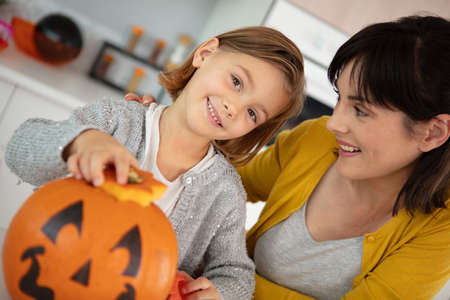 mother and daughter with home made pumpkin at halloweenの写真素材