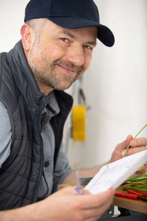 a man with blueprint indoorsの写真素材