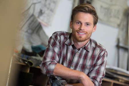 smile and happy man on woodworking in the carpentryの写真素材