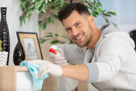 handsome concentrated man cleaning his flatの写真素材
