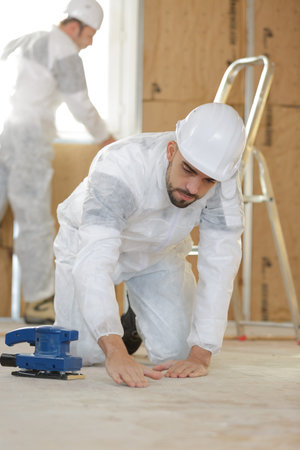 tile installer inspecting the flooring