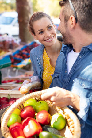 young couple buying fruits and vegetables in a marketの写真素材