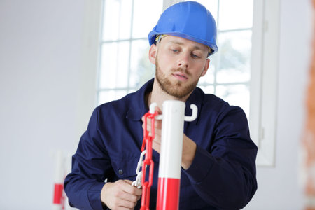 a man builder is fixing chainsの写真素材