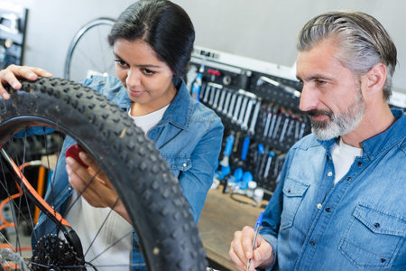 portrait of a female bike repairing apprentice