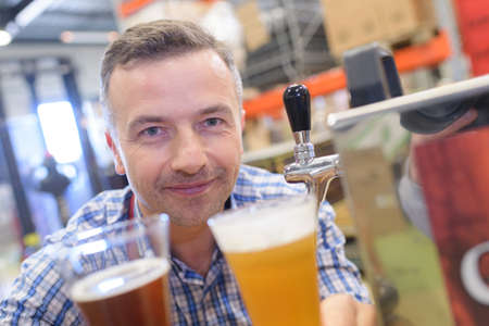 a man holding beer varietyの写真素材