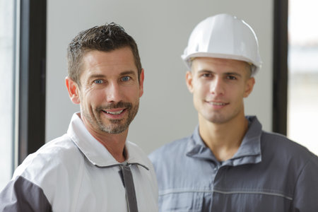 portrait workers at plastering work