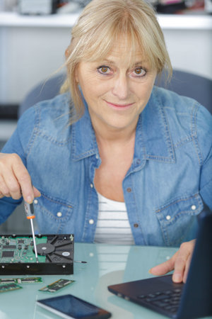 woman repairs pc using screw driver