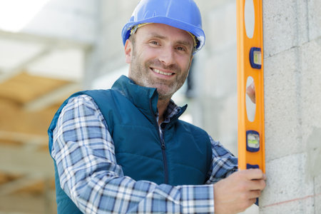 portrait of a builder man with level
